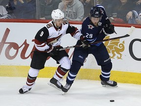 Winnipeg Jets forward Patrik Laine (right) almost has his pocket picked by Arizona Coyotes centre Clayton Keller in Winnipeg on Tuesday, Feb. 6, 2018.