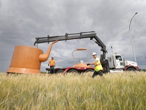 Renowned Canadian Artist, Ian August, supervises the unloading of his piece Rooster Town Kettle.  The sculpture is one of seven artworks created for the Southwest Rapid Transitway, in Winnipeg. Tuesday, Aug. 6, 2019. Chris Procaylo/Winnipeg Sun/Postmedia Network