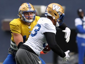 Quarterback Chris Streveler (left) practices the read-option play with running back Andrew Harris during Winnipeg Blue Bombers practice at IG Field in Winnipeg on Tuesday.