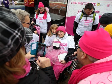 Marlo Jurkowski (centre) displays the friends and family team challenge award which Team Marlo took for the second straight year during the 28th annual Run for the Cure event for the Canadian Cancer Society, in Winnipeg on Sun., Oct. 6, 2019. Kevin King/Winnipeg Sun/Postmedia Network