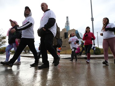 Participants cross Israel Asper Way on their way back to Shaw Park during the 28th annual Run for the Cure event for the Canadian Cancer Society, in Winnipeg on Sun., Oct. 6, 2019. Kevin King/Winnipeg Sun/Postmedia Network
