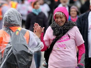 A volunteer and participant high-five near the end of the 28th annual Run for the Cure event for the Canadian Cancer Society, in Winnipeg on Sun., Oct. 6, 2019. Kevin King/Winnipeg Sun/Postmedia Network
