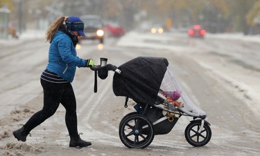 Chantal Young crosses Tuxedo Avenue at Doncaster Street with her child in the Tuxedo area of Winnipeg on Thurs., Oct. 10, 2019. Kevin King/Winnipeg Sun/Postmedia Network
