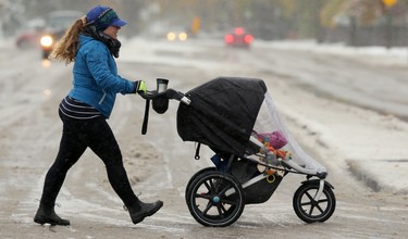 Chantal Young crosses Tuxedo Avenue at Doncaster Street with her child in the Tuxedo area of Winnipeg on Thurs., Oct. 10, 2019. Kevin King/Winnipeg Sun/Postmedia Network