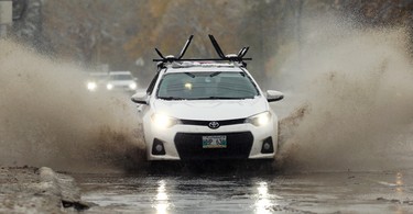 A car splashes through a puddle on Tuxedo Avenue in Winnipeg on Thurs., Oct. 10, 2019. Kevin King/Winnipeg Sun/Postmedia Network