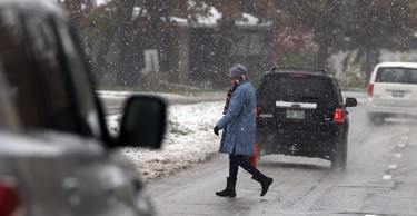 A woman crosses Kenaston Boulevard near Willow Avenue in Winnipeg on Thurs., Oct. 10, 2019. Kevin King/Winnipeg Sun/Postmedia Network