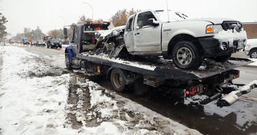 A Ford Ranger that hit a light standard and had its gas tank ripped open sits on a flatbed tow truck on Kenaston Boulevard near Tuxedo Avenue in Winnipeg on Thurs., Oct. 10, 2019. Kevin King/Winnipeg Sun/Postmedia Network