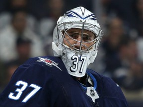 Winnipeg Jets goaltender Connor Hellebuyck gives a look after making a save against the Minnesota Wild during NHL action in Winnipeg on Thurs., Oct. 10, 2019. Kevin King/Winnipeg Sun/Postmedia Network