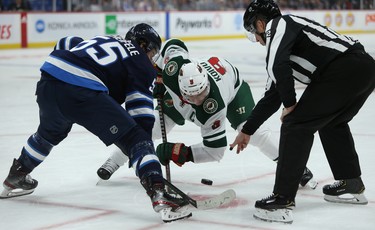 Minnesota Wild centre Mikko Koivu (right) beats Winnipeg Jets centre Mark Scheifele in the faceoff circle during NHL action in Winnipeg on Thurs., Oct. 10, 2019. Kevin King/Winnipeg Sun/Postmedia Network