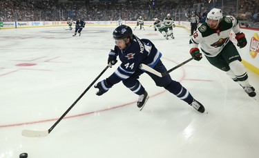 Winnipeg Jets defenceman Josh Morrissey (left) turns away from Minnesota Wild centre Eric Staal during NHL action in Winnipeg on Thurs., Oct. 10, 2019. Kevin King/Winnipeg Sun/Postmedia Network