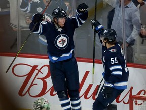 Winnipeg Jets forward Patrik Laine (left) celebrates his second-period goal against the Minnesota Wild during NHL action in Winnipeg with centre Mark Scheifele on Thurs., Oct. 10, 2019. Kevin King/Winnipeg Sun/Postmedia Network