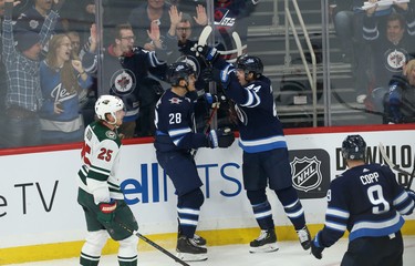 Winnipeg Jets centre Jack Roslovic (left) celebrates his third-period goal against the Minnesota Wild during NHL action in Winnipeg with defenceman Josh Morrissey on Thurs., Oct. 10, 2019. Kevin King/Winnipeg Sun/Postmedia Network