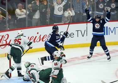 Winnipeg Jets centre Jack Roslovic (centre) celebrates his third-period goal against the Minnesota Wild during NHL action in Winnipeg with defenceman Josh Morrissey on Thurs., Oct. 10, 2019. Kevin King/Winnipeg Sun/Postmedia Network