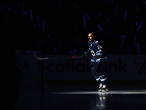 Winnipeg Jets forward Mathieu Perreault skates out during player introductions prior to the team's home opener against the Minnesota Wild in Winnipeg on Thurs., Oct. 10, 2019. Kevin King/Winnipeg Sun/Postmedia Network