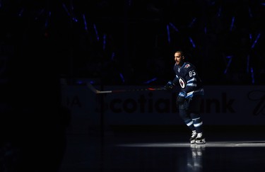 Winnipeg Jets forward Mathieu Perreault skates out during player introductions prior to the team's home opener against the Minnesota Wild in Winnipeg on Thurs., Oct. 10, 2019. Kevin King/Winnipeg Sun/Postmedia Network