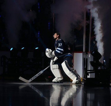 Winnipeg Jets goaltender Connor Hellebuyck skates out during player introductions prior to the team's home opener against the Minnesota Wild in Winnipeg on Thurs., Oct. 10, 2019. Kevin King/Winnipeg Sun/Postmedia Network