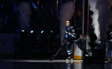 Winnipeg Jets defenceman Ville Heinola skates out during player introductions prior to the team's home opener against the Minnesota Wild in Winnipeg on Thurs., Oct. 10, 2019. Kevin King/Winnipeg Sun/Postmedia Network