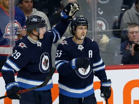 Winnipeg Jets centre Mark Scheifele (right) celebrates his second-period goal against the Pittsburgh Penguins with forward Patrik Laine during NHL action in Winnipeg on Sun., Oct. 13, 2019. Kevin King/Winnipeg Sun/Postmedia Network