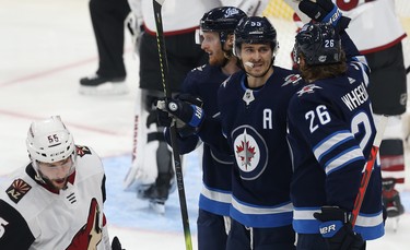 Winnipeg Jets centre Mark Scheifele (centre) celebrates his power-play goal against the Phoenix Coyotes during NHL action in Winnipeg with Kyle Connor (left) and Blake Wheeler on Tues., Oct. 15, 2019. Kevin King/Winnipeg Sun/Postmedia Network