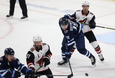 Winnipeg Jets centre David Gustafsson (left) is checked by Phoenix Coyotes defenceman Jordan Oesterle during NHL action in Winnipeg on Tues., Oct. 15, 2019. Kevin King/Winnipeg Sun/Postmedia Network