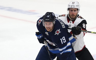 Winnipeg Jets centre David Gustafsson (left) is checked by Phoenix Coyotes defenceman Jordan Oesterle during NHL action in Winnipeg on Tues., Oct. 15, 2019. Kevin King/Winnipeg Sun/Postmedia Network