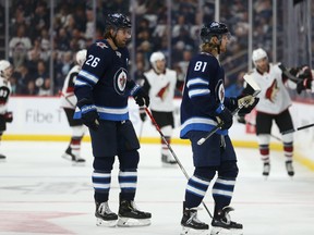 Winnipeg Jets forwards Blake Wheeler (left) and Kyle Connor head to the bench after a Phoenix Coyotes goal during NHL action in Winnipeg on Tuesday.