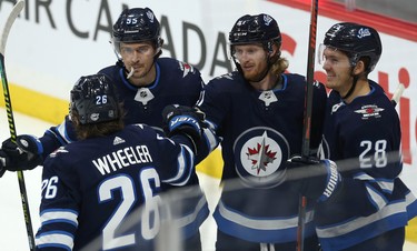 Winnipeg Jets forward Kyle Connor (second from right) celebrates his power-play goal during the third period of NHL action against the Phoenix Coyotes with Blake Wheeler, Mark Scheifele and Jack Roslovic (from left) in Winnipeg on Tues., Oct. 15, 2019. Kevin King/Winnipeg Sun/Postmedia Network