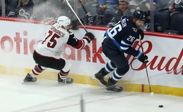 Winnipeg Jets forward Blake Wheeler (right) spins away from the check of Phoenix Coyotes defenceman Kyle Capobianco during NHL action in Winnipeg on Tues., Oct. 15, 2019. Kevin King/Winnipeg Sun/Postmedia Network