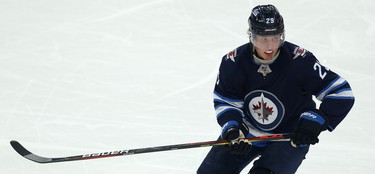 Winnipeg Jets forward Patrik Laine skates with blood on his chin after catching a high stick from Phoenix Coyotes forward Connor Garland during NHL action in Winnipeg on Tues., Oct. 15, 2019. Kevin King/Winnipeg Sun/Postmedia Network