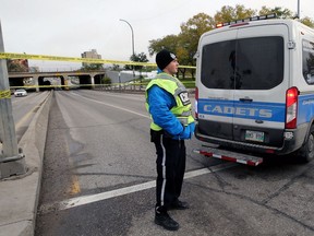 A police cadet blocks northbound Main Street at Higgins Avenue in Winnipeg on Wednesday.