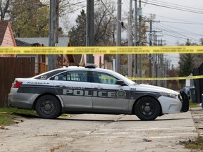 A police vehicle sits in the backlane behind an apartment building that was the scene of a fatal stabbing at 345 Talbot Avenue in Winnipeg on Wed., Oct. 23, 2019. Kevin King/Winnipeg Sun/Postmedia Network