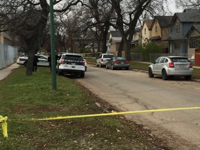 Police vehicles and tape outside of a house in the 400 block of Flora Avenue in Winnipeg where police were called on Sunday at around 3:15 p.m., after police said an individual fired a shotgun into the residence injuring three adults and an infant child under the age of two. All four were taken to hospital, two in critical condition and two in stable.