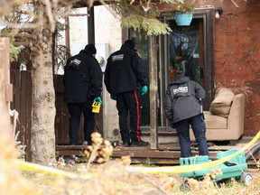 Forensics officers investigate at the rear of a residence in the 100 block of Kinver Avenue in Winnipeg on Sun., Oct. 27, 2019. A 14-year-old girl was killed and an 18-year-old is in hospital in stable condition after they were stabbed. Kevin King/Winnipeg Sun/Postmedia Network