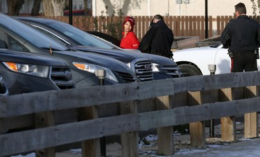 Officers take a woman into custody who came out of a multi-unit dwelling at the scene of an apparent armed and barricaded incident on Pacific Avenue between Ellen and Paulin streets in Winnipeg on Thurs., Oct. 31, 2019. The tactical unit and armoured vehicle were on scene, as well as a police negotiator and an ambulance on standby for what police say came in as an armed robbery call just before 5 a.m. on Thursday morning. Officers could be heard using a megaphone asking people inside the home to come out with their arms in the air. Kevin King/Winnipeg Sun/Postmedia Network