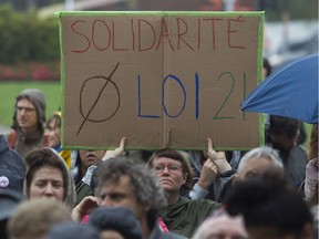 Bronwen Agnew holds up a sign at a rally that teachers organized against Bill 21 in Montreal Saturday, September 28, 2019 outside the Parc metro station.