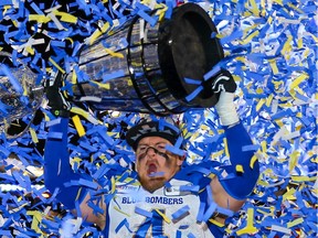 Winnipeg Blue Bombers Adam Bighill celebrates with the Grey Cup after defeating the Hamilton Tiger-Cats in the 107th Grey Cup in Calgary on Sunday, November 24, 2019.