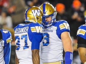 Brandon Alexander (left) and Thiadric Hansen of the Winnipeg Blue Bombers celebrate after a play against the Hamilton Tiger-Cats during the 107th Grey Cup Championship Game at McMahon Stadium on Sunday.