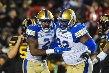 CALGARY, AB - NOVEMBER 24: Jonathan Kongbo #2 (L) and Drake Nevis #92 of the Winnipeg Blue Bombers react after a play against the Hamilton Tiger-Cats during the 107th Grey Cup Championship Game at McMahon Stadium on November 24, 2019 in Calgary, Alberta, Canada. (Photo by Derek Leung/Getty Images)