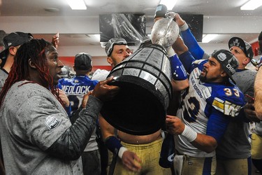 CALGARY, AB - NOVEMBER 24: Andrew Harris #33 (R) of the Winnipeg Blue Bombers celebrates with his teammates after defeating the Hamilton Tiger-Cats during the 107th Grey Cup Championship Game at McMahon Stadium on November 24, 2019 in Calgary, Alberta, Canada. (Photo by Derek Leung/Getty Images)