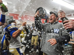 CALGARY, AB - NOVEMBER 24: Andrew Harris #33 of the Winnipeg Blue Bombers celebrates with his teammates after defeating the Hamilton Tiger-Cats during the 107th Grey Cup Championship Game at McMahon Stadium on November 24, 2019 in Calgary, Alberta, Canada. (Photo by Derek Leung/Getty Images)