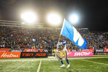 CALGARY, AB - NOVEMBER 24: Brandon Alexander #37 of the Winnipeg Blue Bombers runs with his team's flag after winning the 107th Grey Cup Championship Game against the Hamilton Tiger-Cats at McMahon Stadium on November 24, 2019 in Calgary, Alberta, Canada. (Photo by Derek Leung/Getty Images)