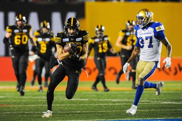 CALGARY, AB - NOVEMBER 24: Jaelon Acklin #80 of the Hamilton Tiger-Cats runs the ball against Brandon Alexander #37 of the Winnipeg Blue Bombers during the 107th Grey Cup Championship Game at McMahon Stadium on November 24, 2019 in Calgary, Alberta, Canada. (Photo by Derek Leung/Getty Images)