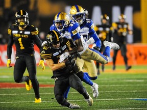 Jaelon Acklin (80) of the Hamilton Tiger-Cats runs the ball against Brandon Alexander (37) of the Winnipeg Blue Bombers during the 107th Grey Cup Championship Game at McMahon Stadium on Nov. 24, 2019 in Calgary.