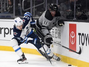 Kings’ Anze Kopitar (right) and the Jets’ Mark Scheifele battle for the puck in Los Angles last night.  Getty Images