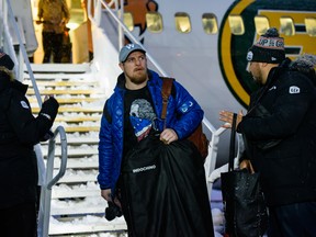 Winnipeg Blue Bombers linebacker Adam Bighill gets off the plane in Calgary for the Grey Cup on Tuesday. (Azin Ghaffari/Postmedia Network)