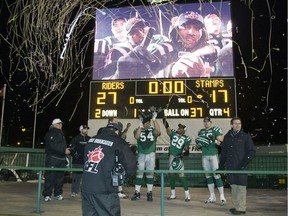 Jeremy O'Day, 54, Eddie Davis, 29, and Mike McCullough, right, celebrate on Nov. 22, 2009 after the Saskatchewan Roughriders defeated the Calgary Stampeders 27-17 in the CFL's West Division final at Taylor Field.