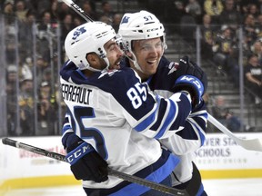 Jets' Mathieu Perreault and Gabriel Bourque celebrate Perreault's goal against the Golden Knights during the first period on Saturday night in Vegas. (THE ASSOCIATED PRESS)