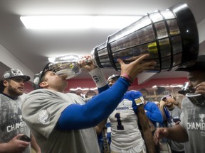 Winnipeg Blue Bombers quarterback Zach Collaros drinks from the Grey Cup. (THE CANADIAN PRESS)
