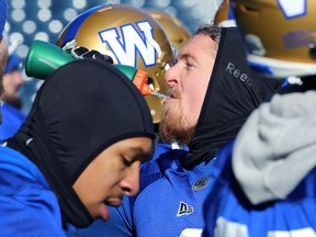 Linebacker Adam Bighill hydrates on the sideline during Blue Bombers practice on Thurs., Nov. 7, 2019. (KEVIN KING/WINNIPEG SUN)