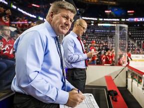 Calgary Flames head coach Bill Peters looks on from the bench during the warmups prior to the game against the New Jersey Devils at Scotiabank Saddledome. (Sergei Belski-USA TODAY Sports)